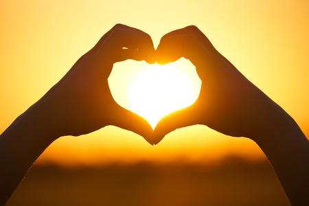 33672307-hands-forming-a-heart-shape-with-sunset-silhouette.jpg